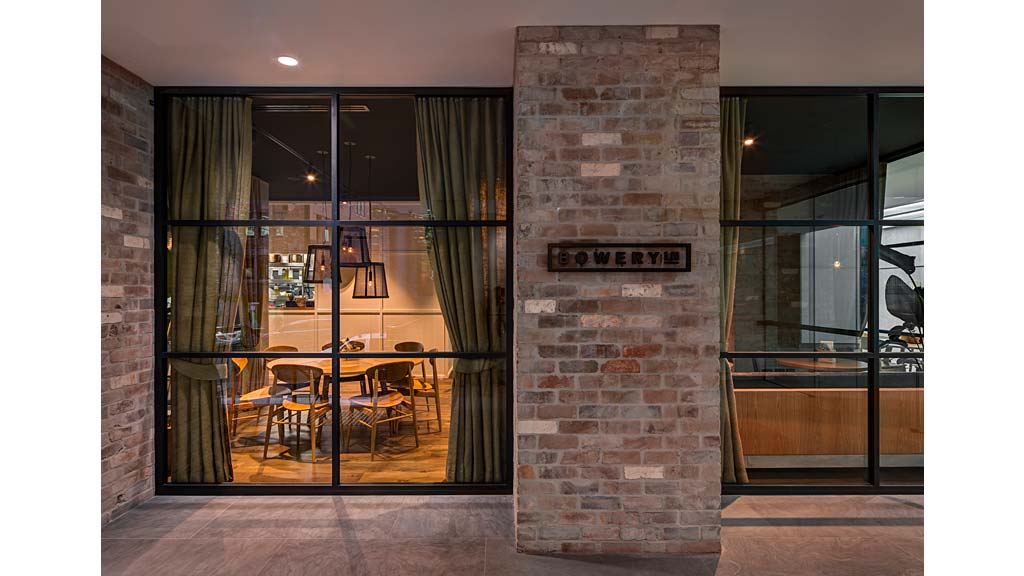 A brick building with a glass door.