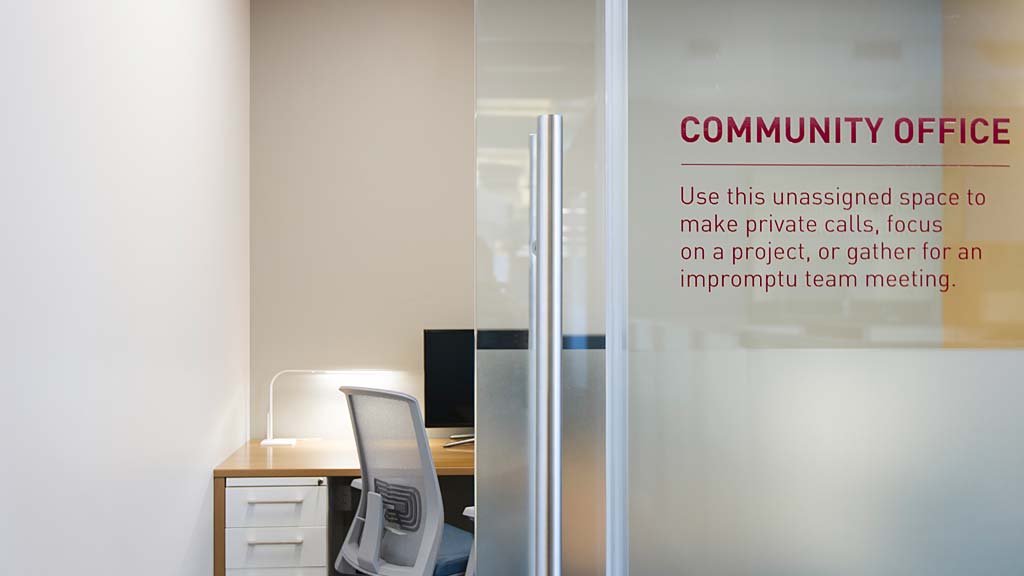 A cubicle with a desk and computer.