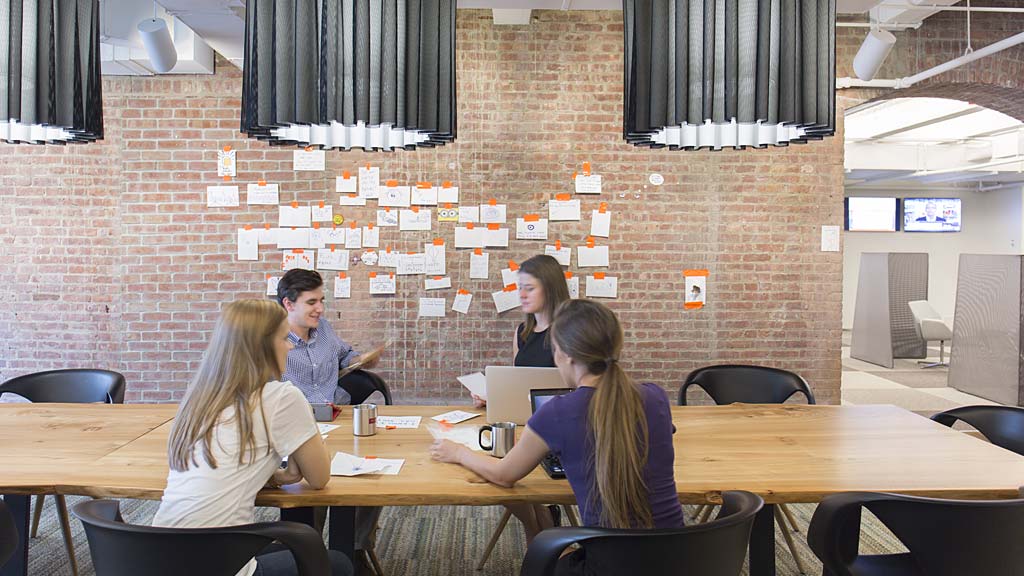 A group of people sitting at tables.