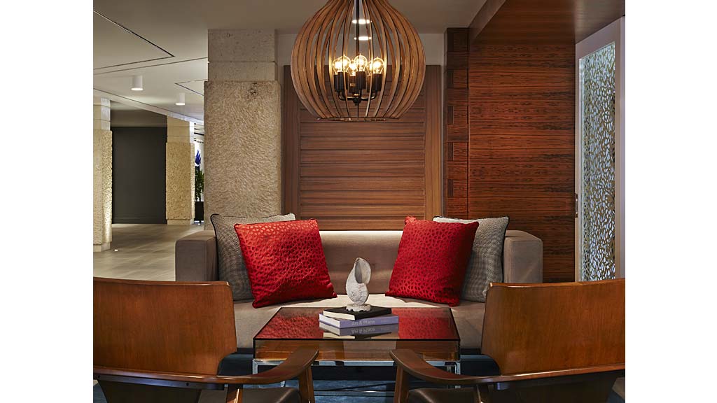 A living room with a chandelier and a couch.