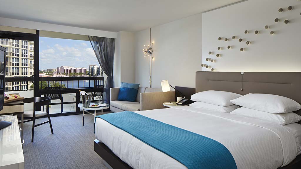 A bedroom with a large window.