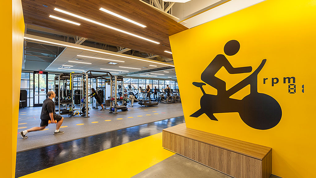 A person sitting on a bench in a gym.
