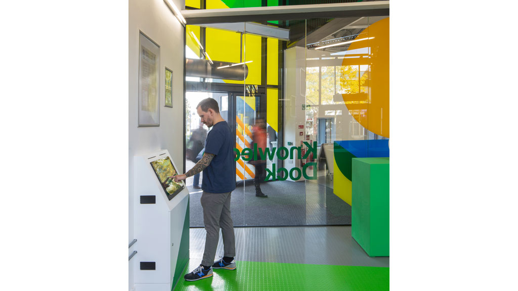 A man looking at a poster.