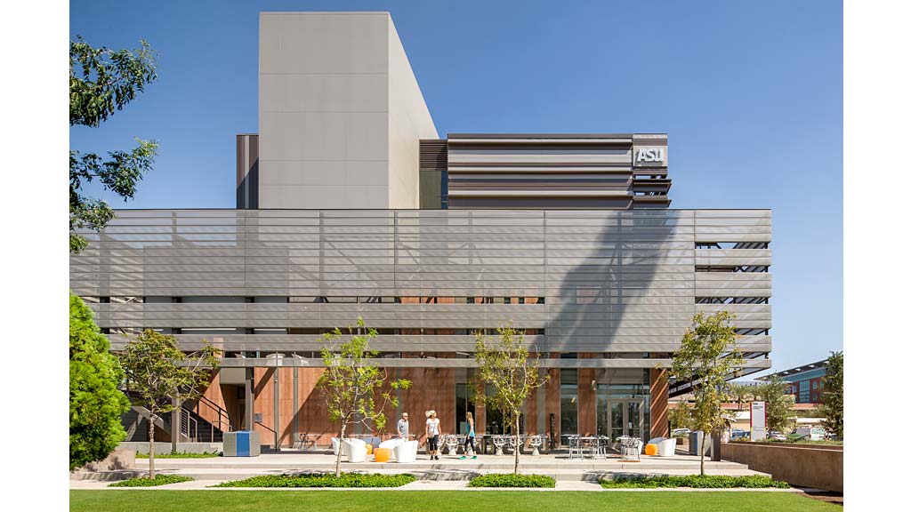 A building with a few people walking out front.