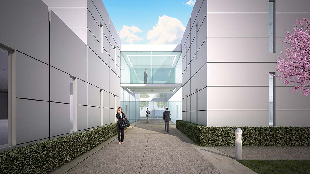 A person walking on a path between buildings.