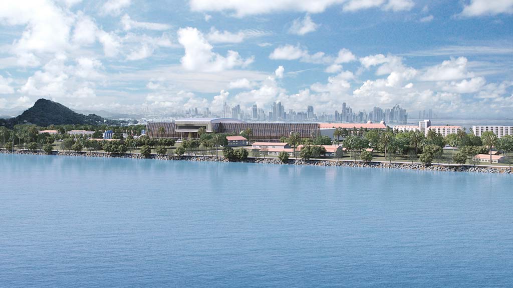 A body of water with buildings and trees in the background.