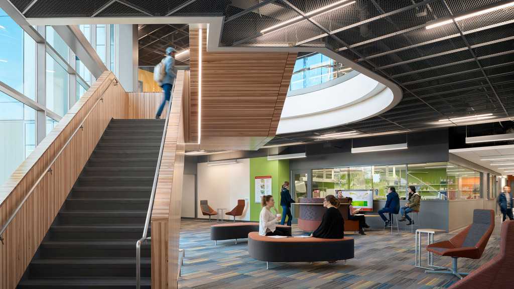 People sitting on stairs in a building.