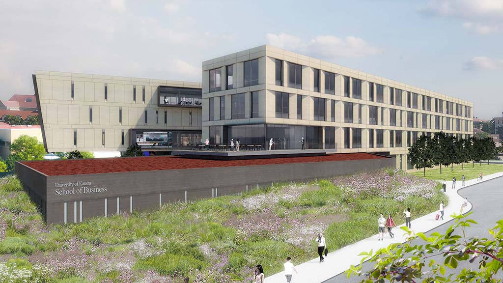 A large building with a courtyard and people walking around.