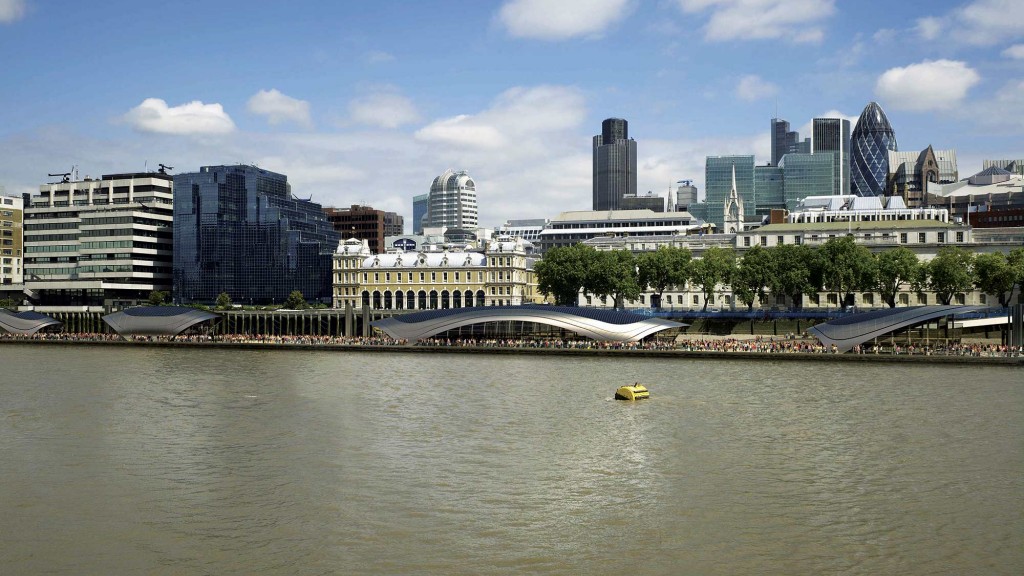 A river with a bridge and buildings in the background.