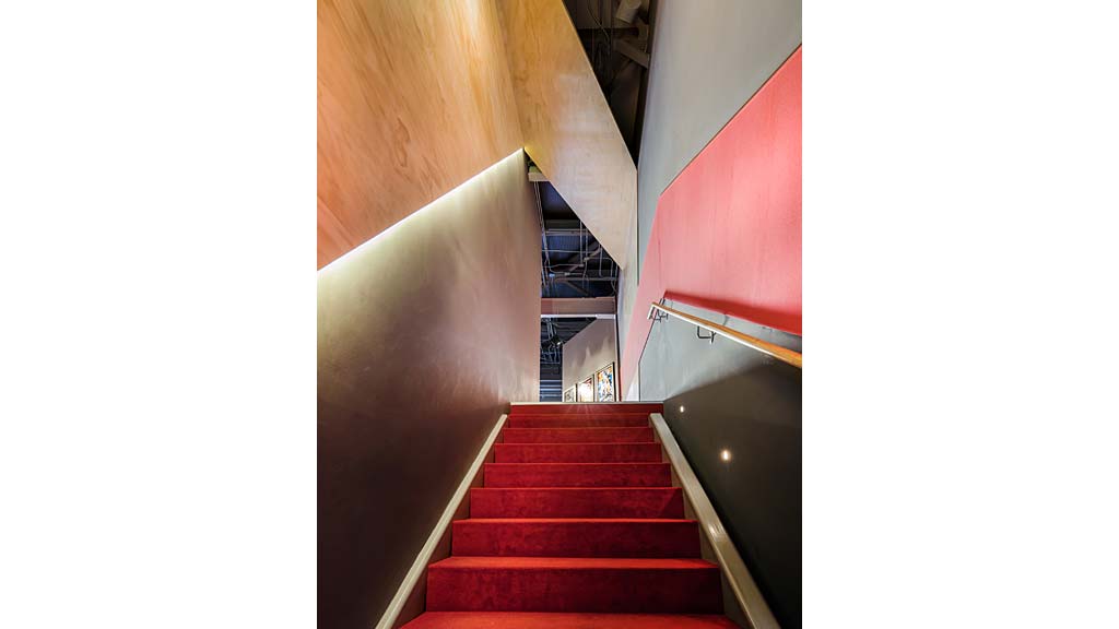 A staircase with red walls.