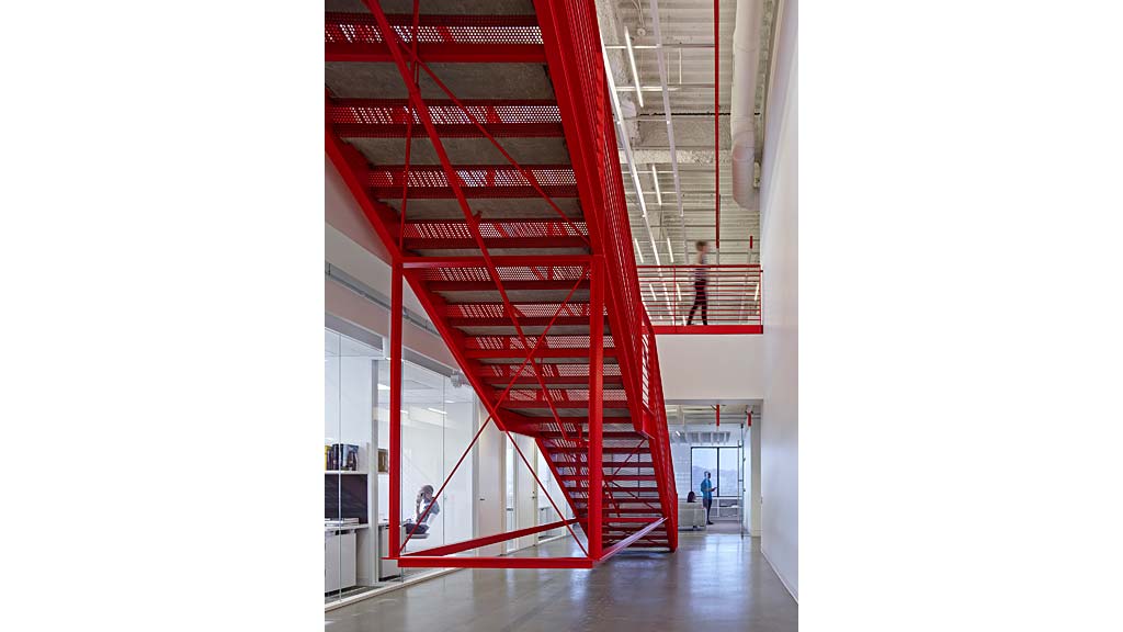 A red staircase in a building.