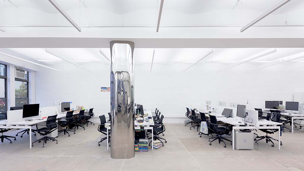 A room with computers and chairs.