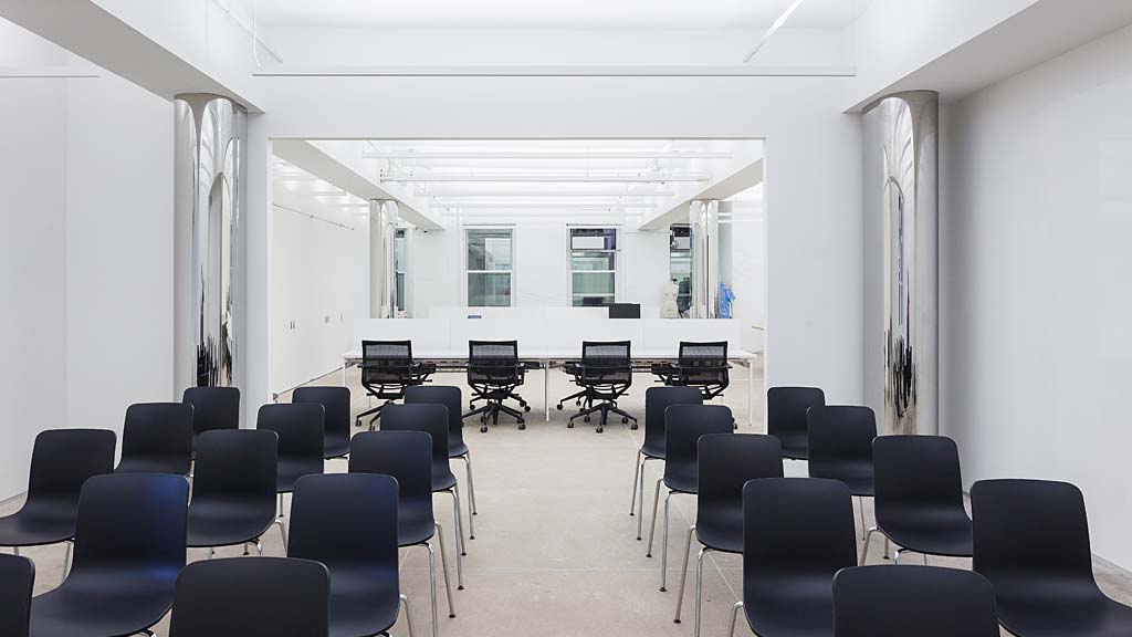 A room with black chairs and tables.