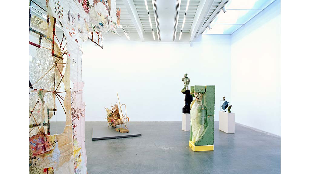A room with statues and a staircase.