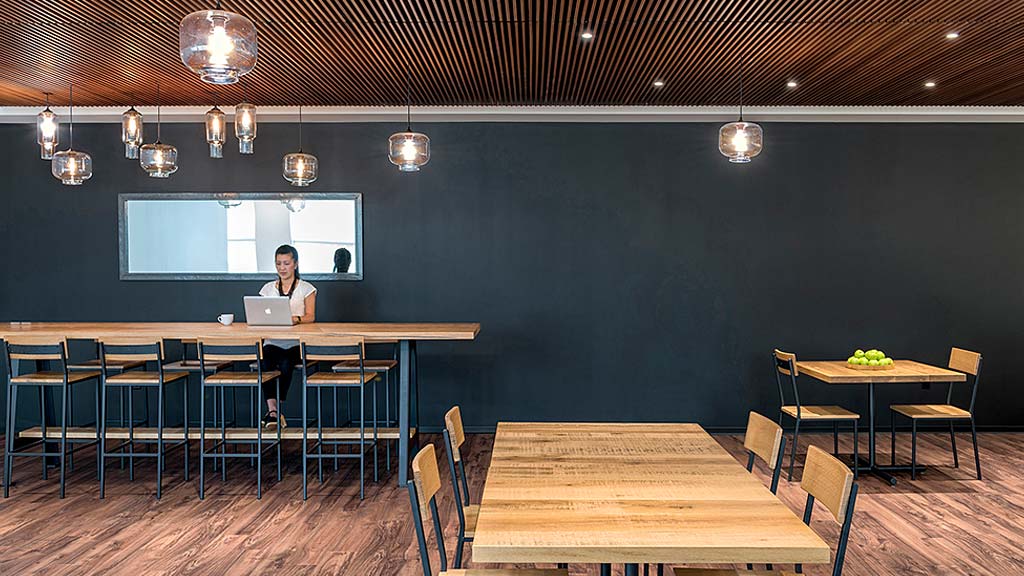 A person sitting at a table with a laptop.