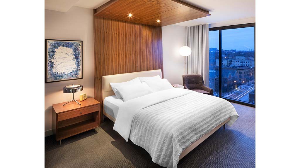 A bed with a large window.