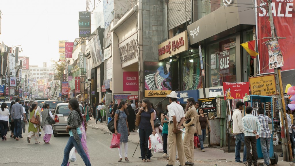 A crowd of people walking on a street.