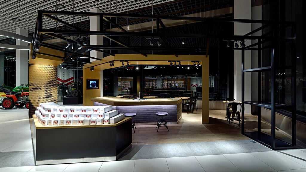 A large building with a large glass front and a large table with a few chairs and a few.