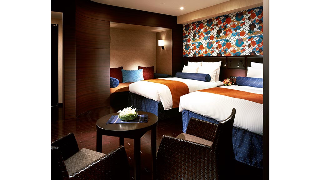 A bedroom with a bed and a chair.