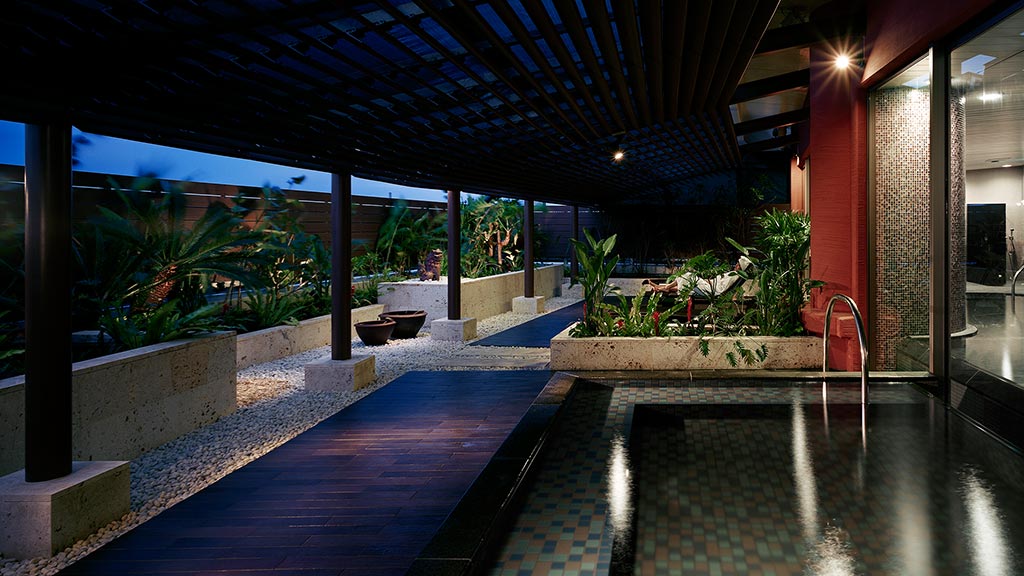 A swimming pool with a covered patio.