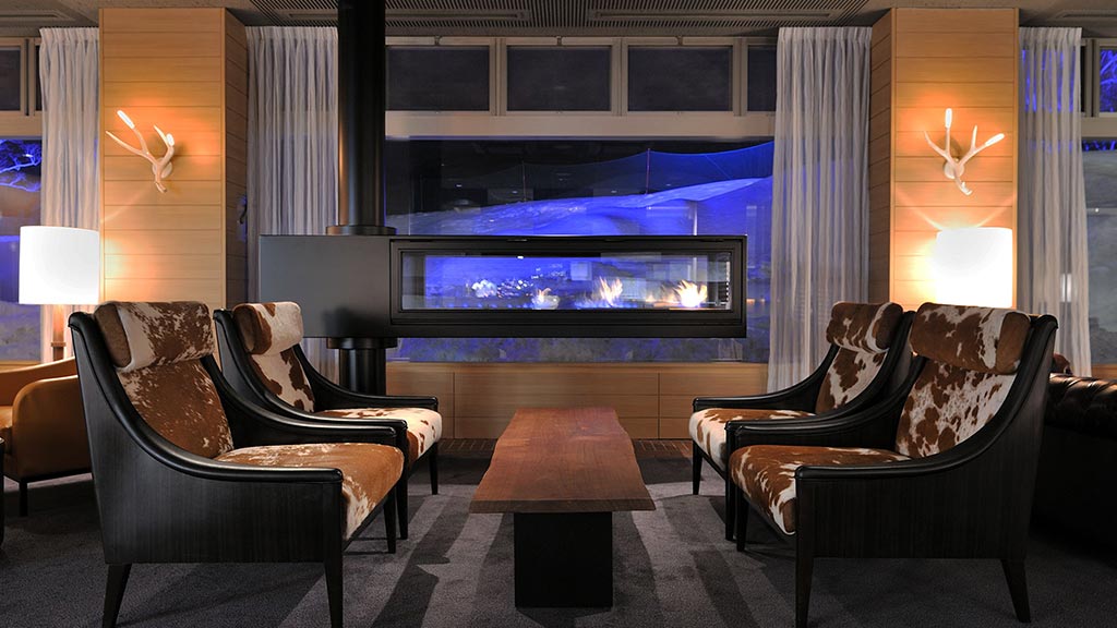 A room with a large screen and chairs.