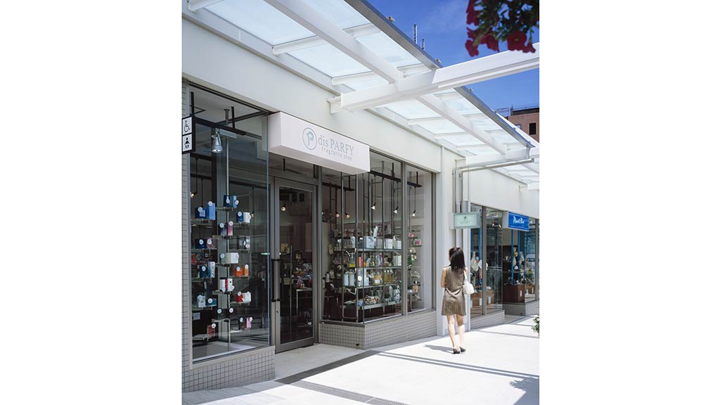 A person walking outside of a store.