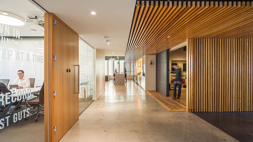 A person standing in a room with a table and chairs.