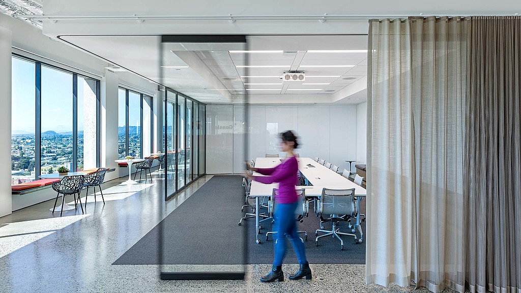 A woman walking in a room.