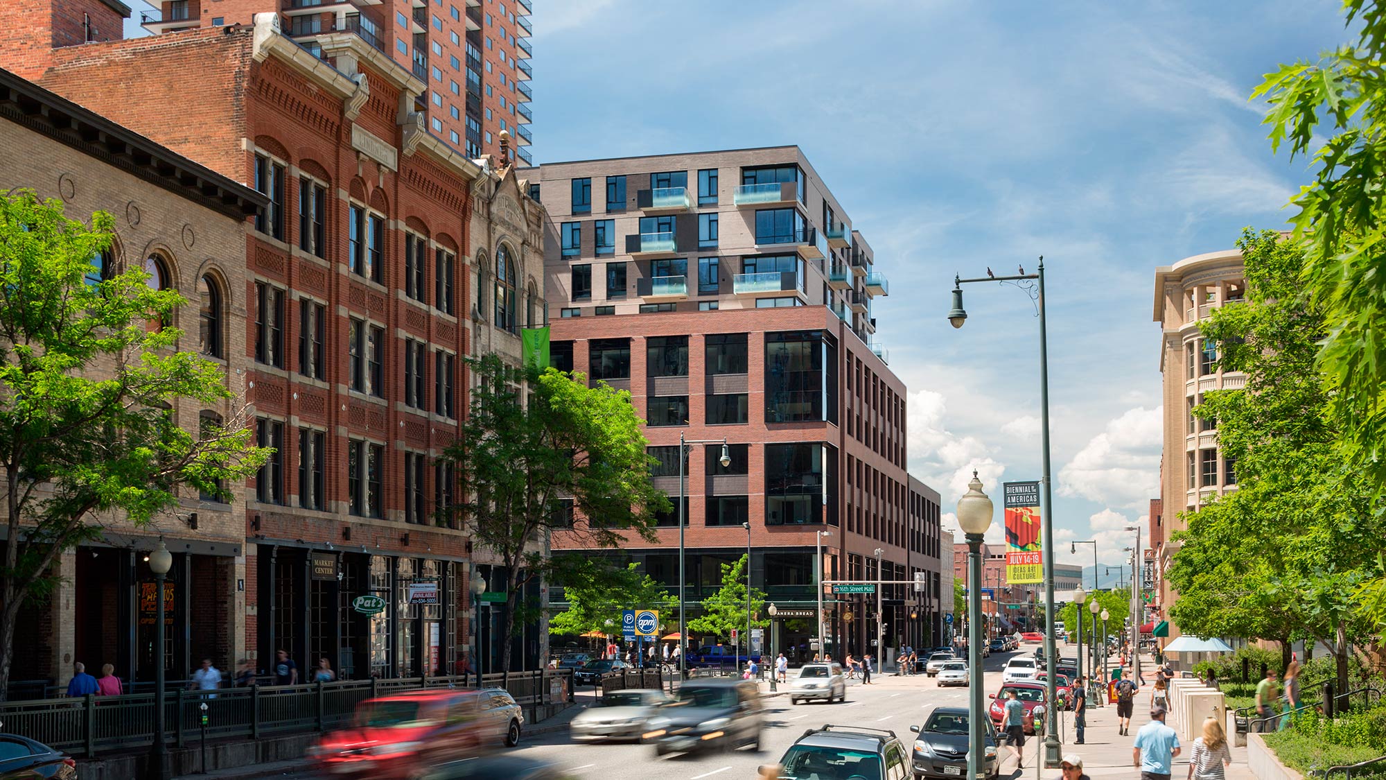 A busy street with cars and people.