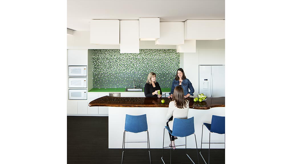 A group of women sitting at a table in a room.
