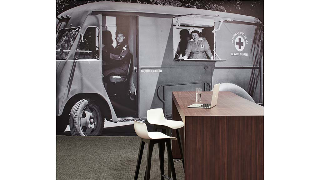 A table and chairs in front of a van.