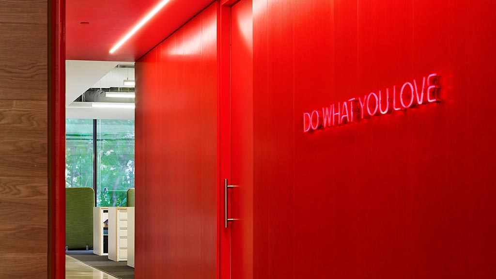 A red wall with a sign on it.