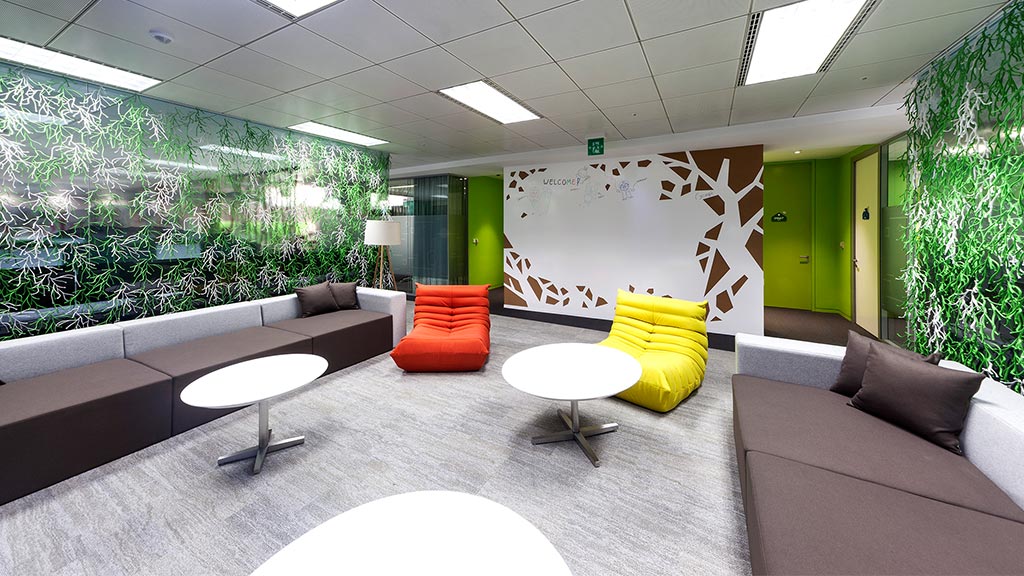 A room with a couch and chairs.