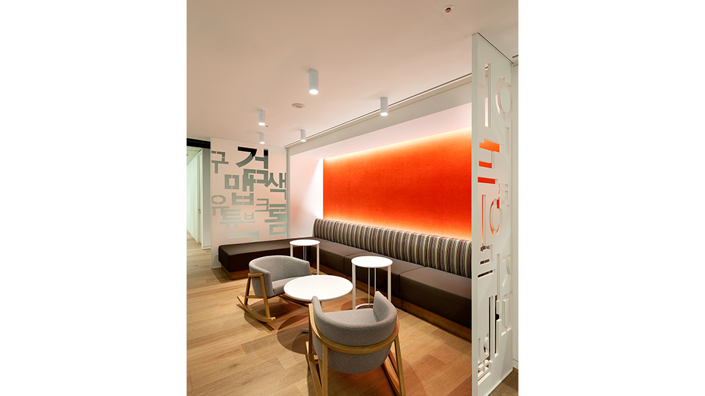 A room with a couch and chairs.