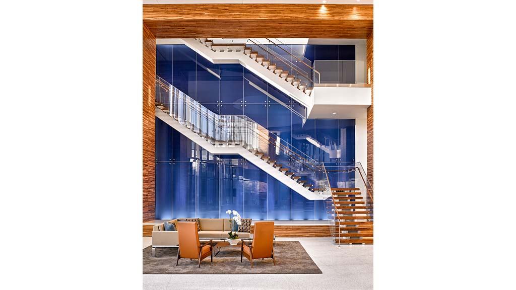 A room with a staircase and chairs.