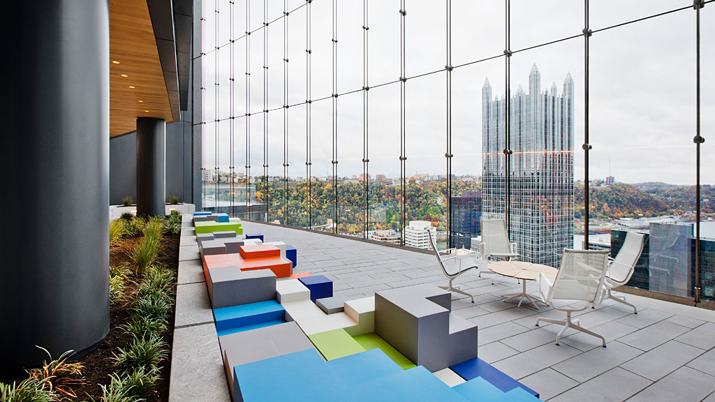 A deck with chairs and a pool.