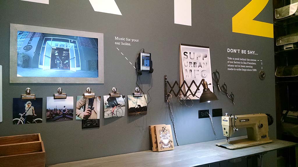 A room with a display of electronic devices and a tv.