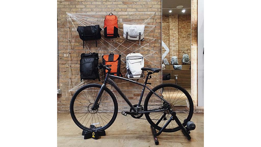 A bicycle parked in front of a brick wall.