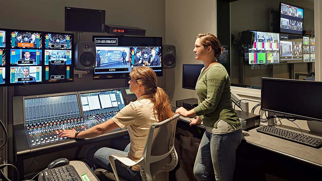 A few women working at a computer.