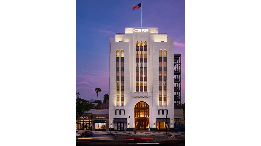 A tall building with a flag on top.