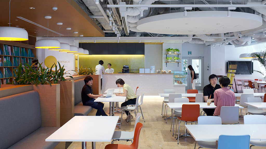A group of people sitting at tables.