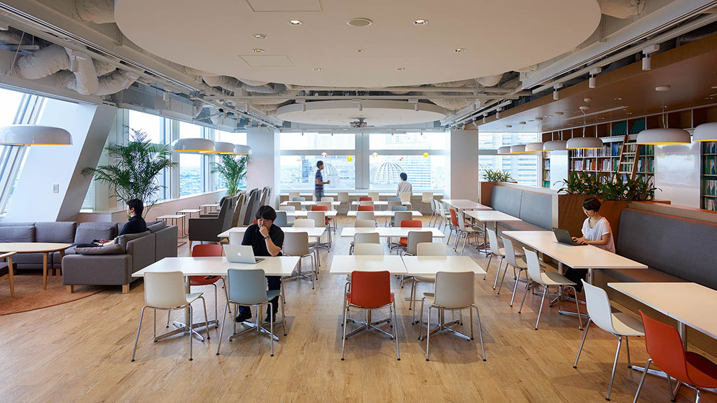 A group of people sitting at tables.