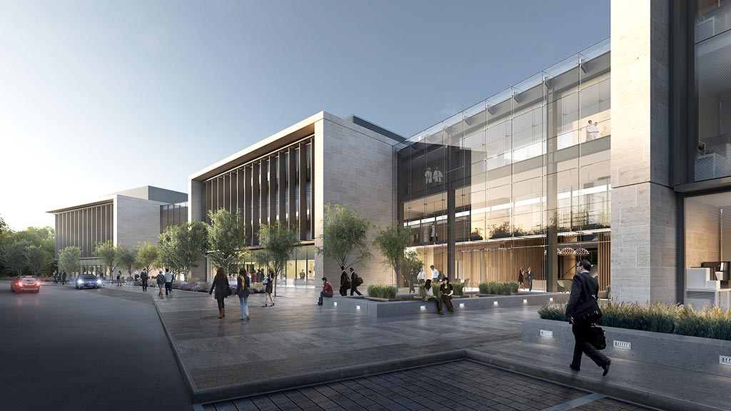 A large building with a courtyard and people walking around.