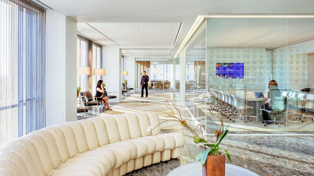 A room with a couch and a table with people in it.