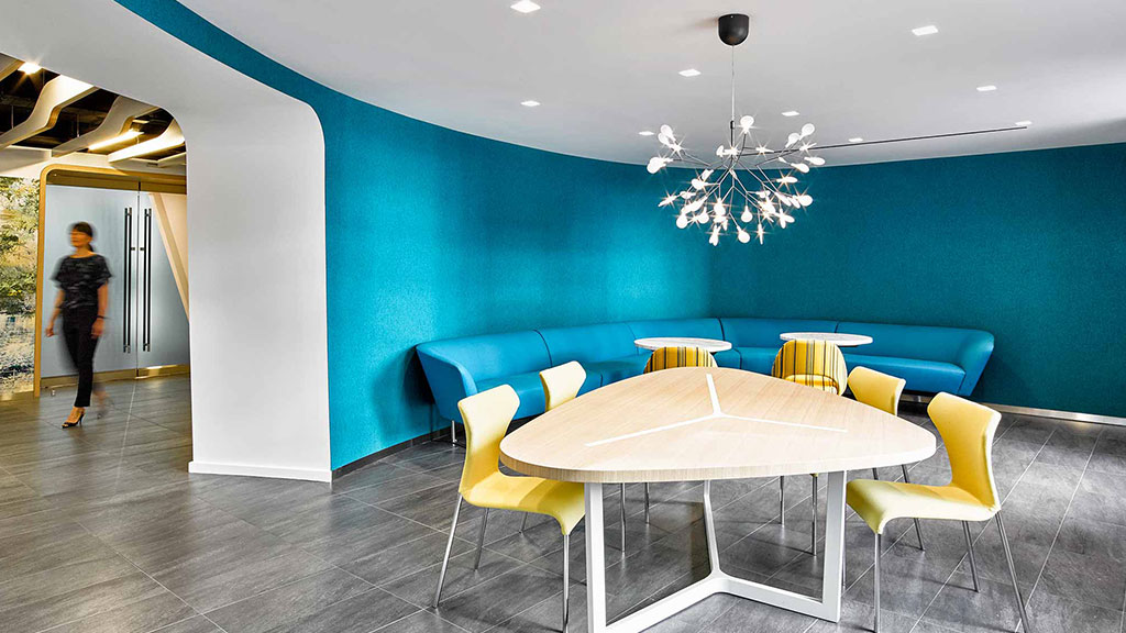 A room with a table chairs and a chandelier.