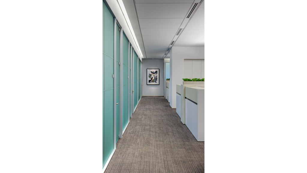 A long hallway with blue doors.