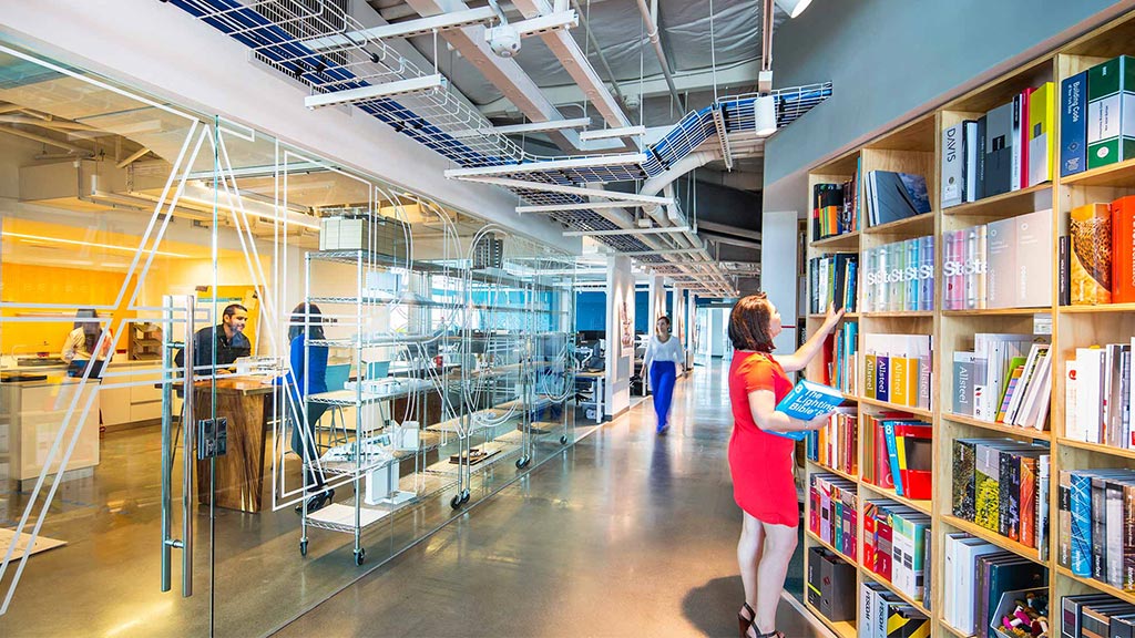 A person standing in a library.