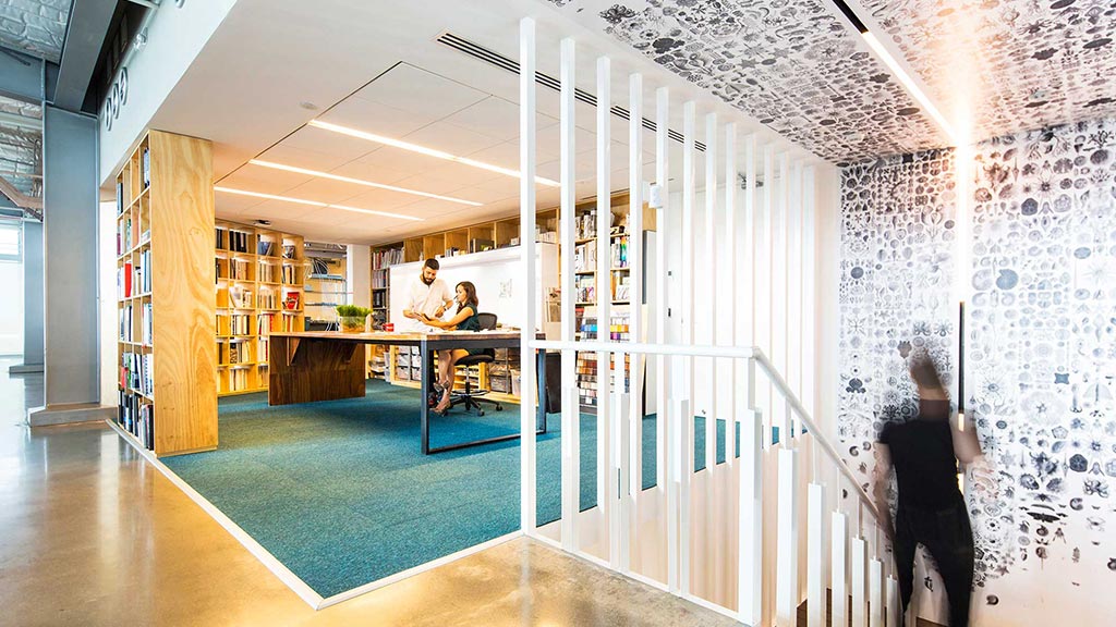 A few people in a library.