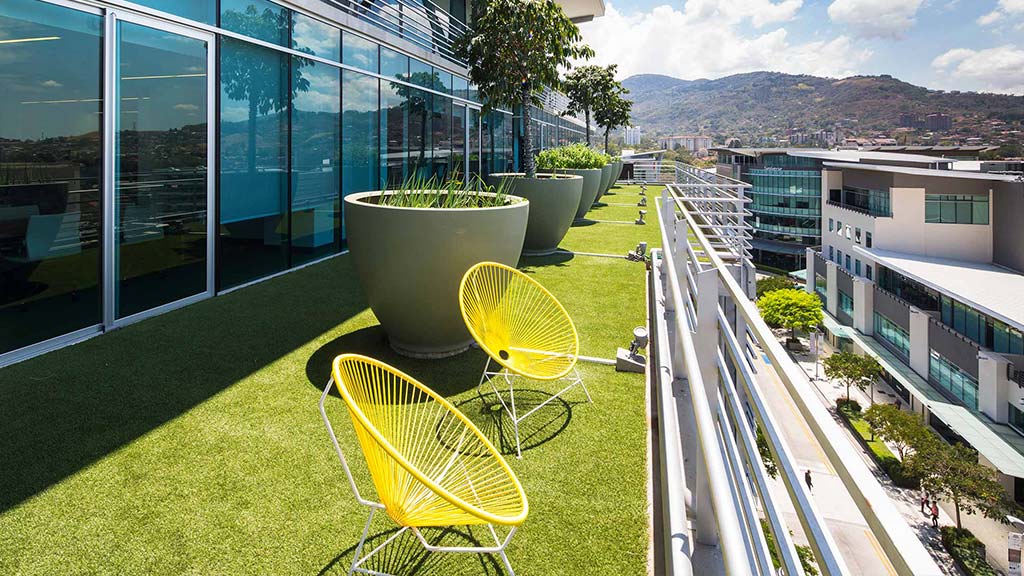 A patio with chairs and a table.