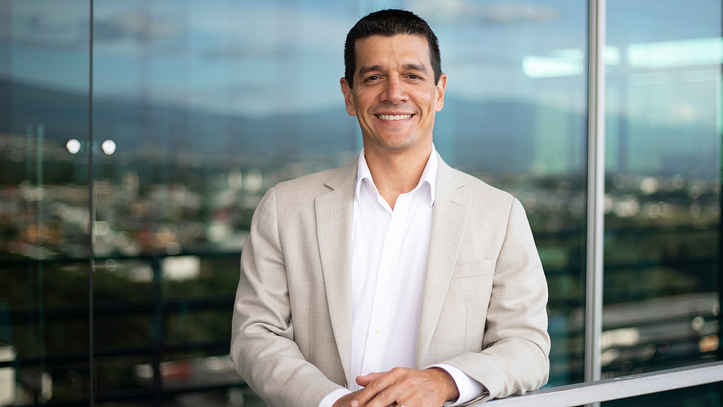 A man in a suit smiling.